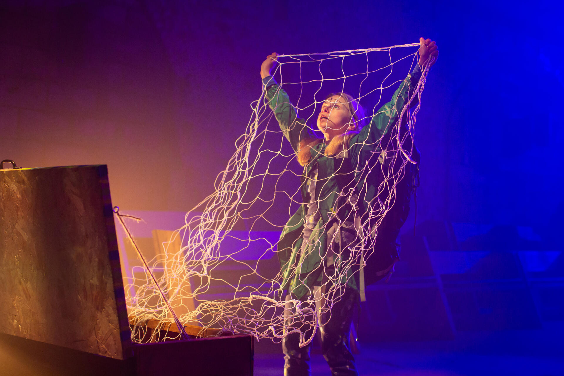 Sandy in Alcatraz holding up a large net
